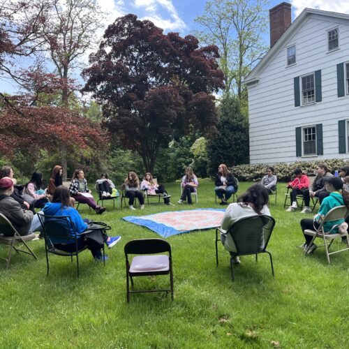 sangha participants sitting in a circle in nature
